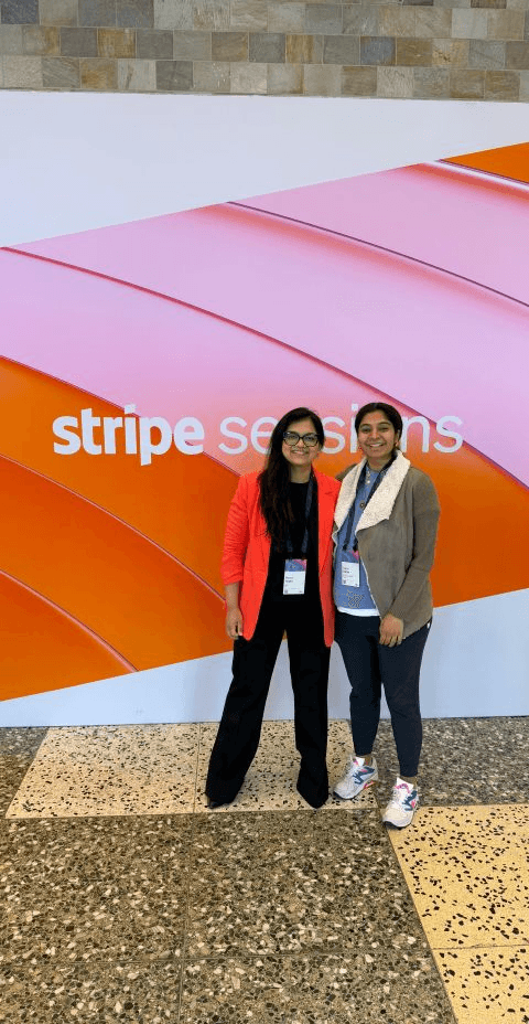 Purva Gupta with Mandeep Bhatia of Tapestry in front of the Stripe Sessions backdrop.