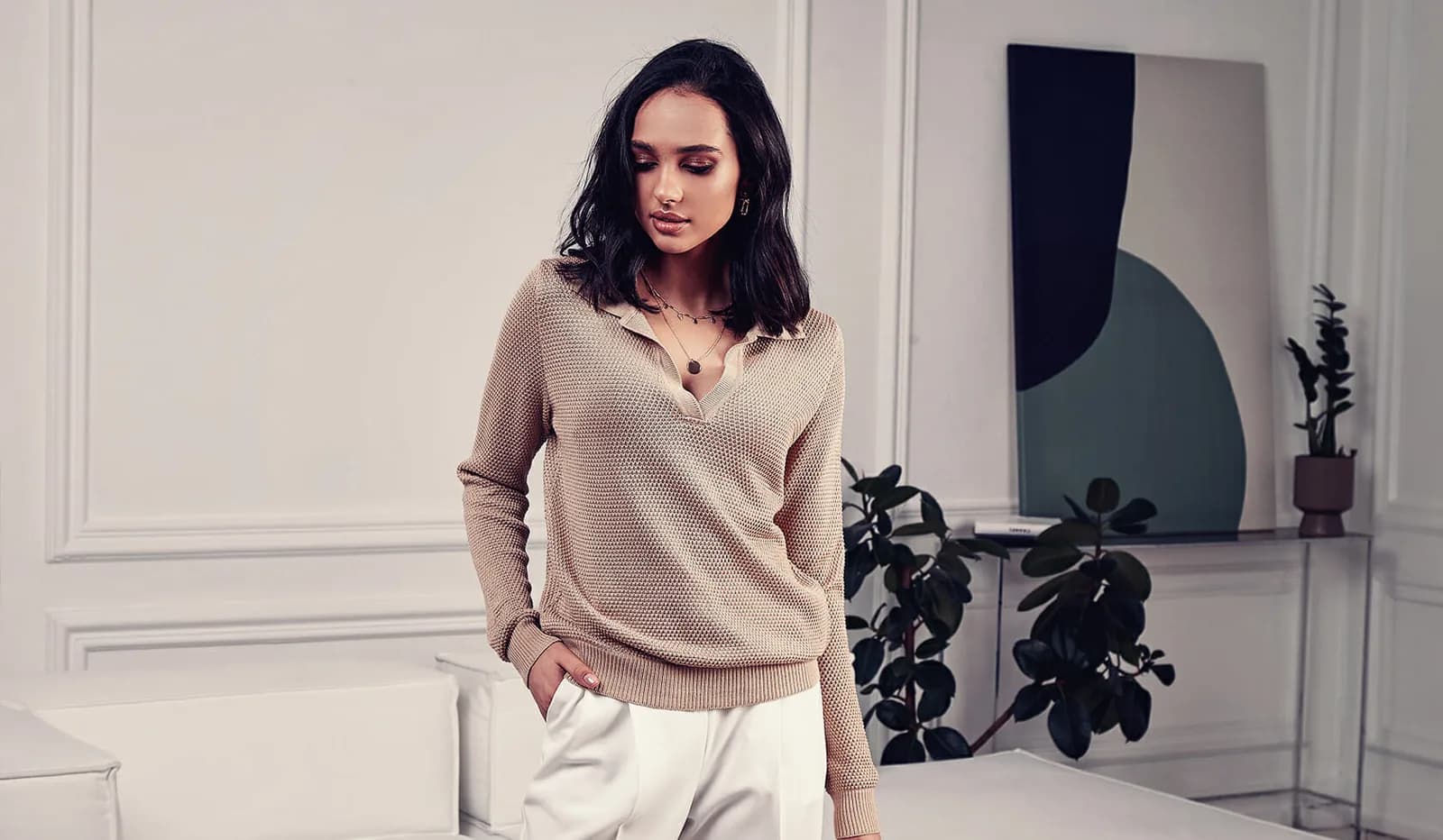 Woman in a tan, neutral, waffle textured, soft touch sweater.