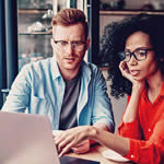 Woman and man reviewing information on their computer.