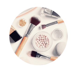 Makeup brushes and cosmetics scattered on a table.