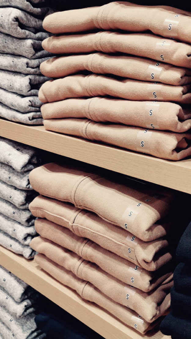 Rows of unsold clothing stock on shelves that can be prevented with Lily AI.