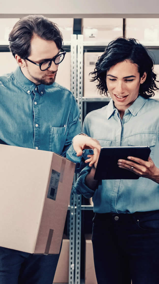 Team of people reviewing products to better prepare their demand intelligence with boxes in their hand.