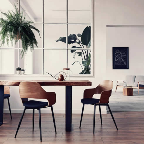 Image of a dining room in a home with mid-century modern tables and chairs.