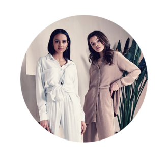Two fashion models posing in neutral loungewear sets.