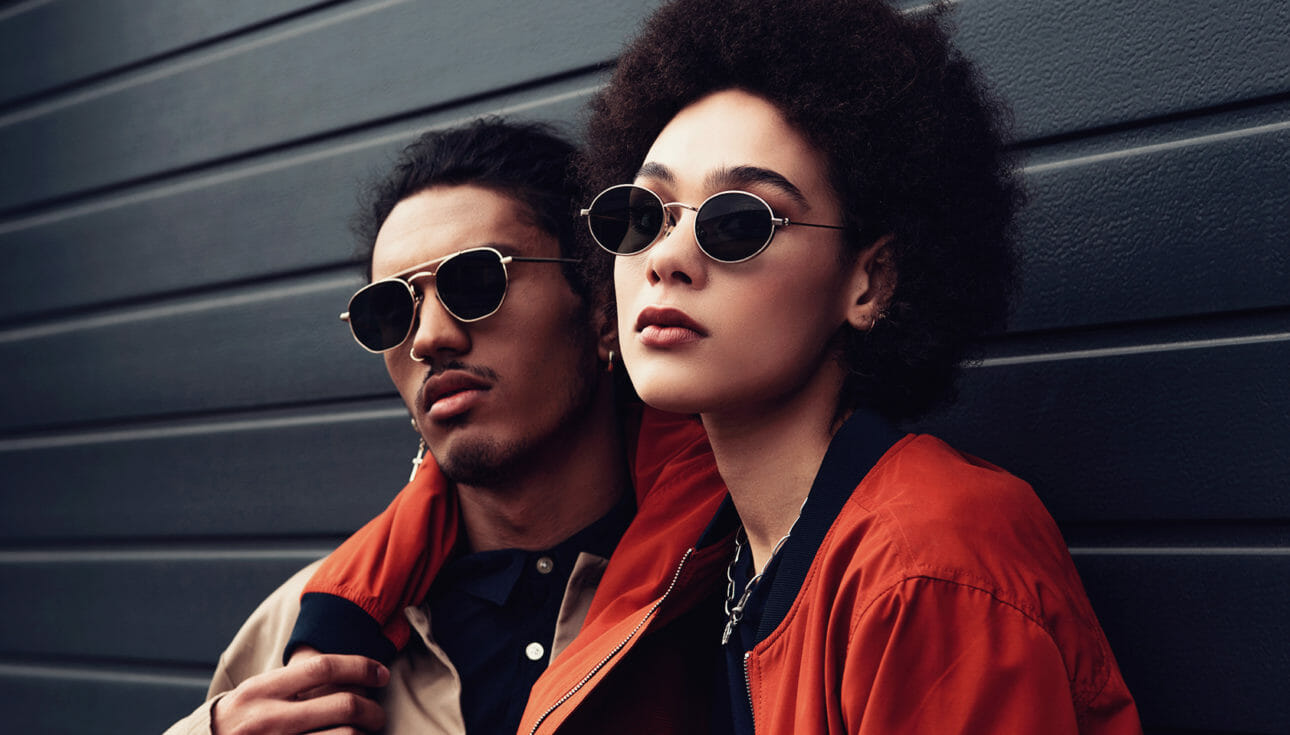 Fashionable man and woman wearing sunglasses on trend for retail shoppers.