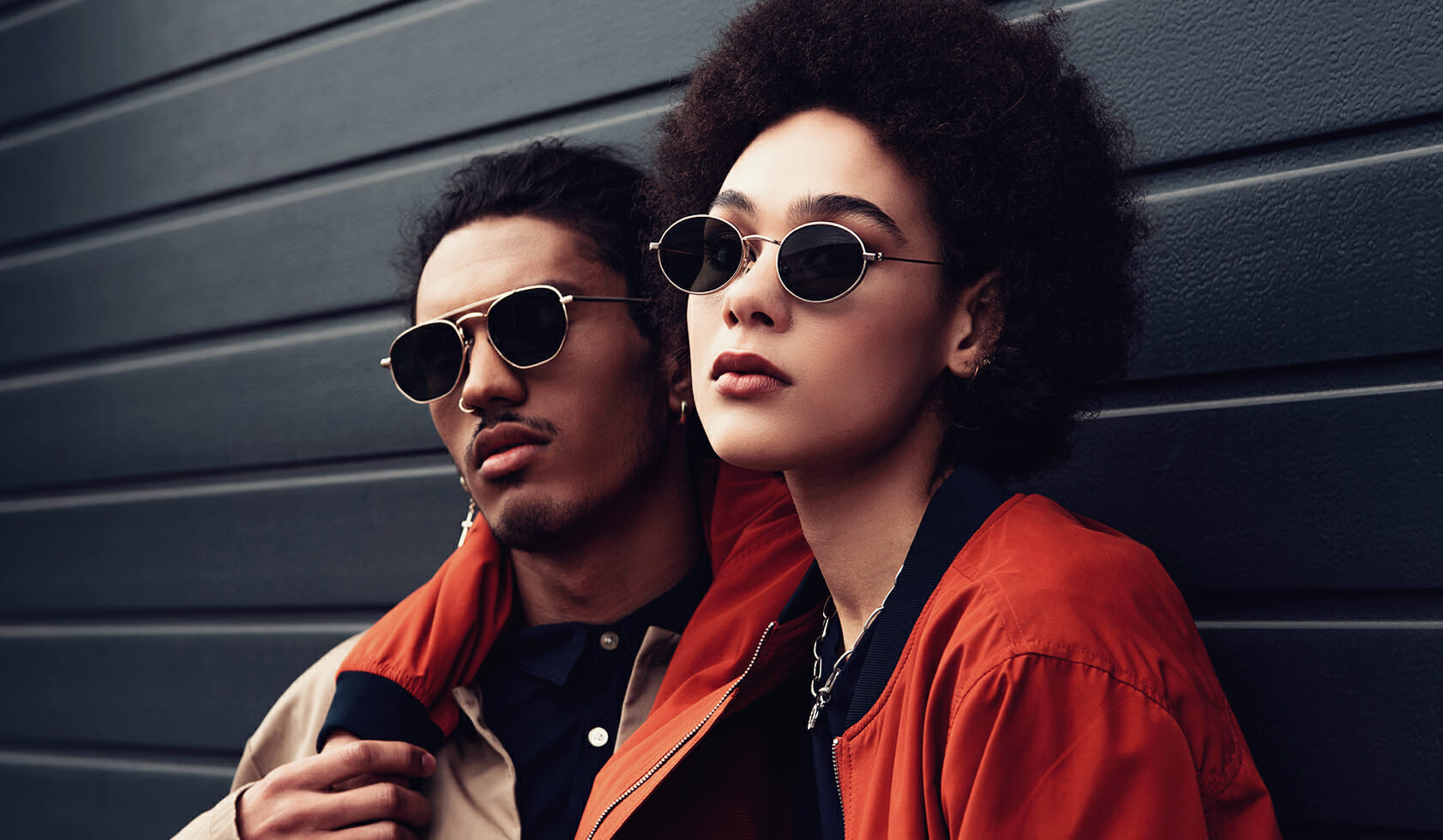 Fashionable man and woman wearing sunglasses on trend for retail shoppers.