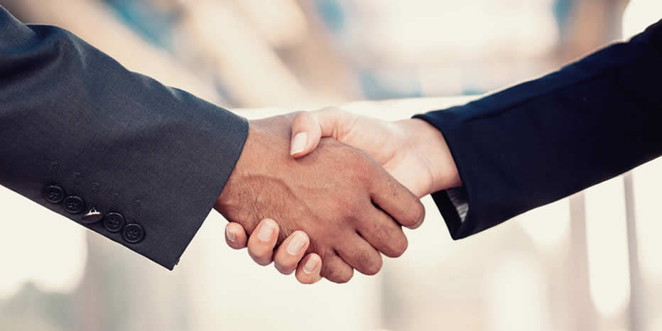 Image of man and woman business partners shaking hands.