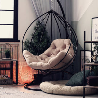 Hanging round metal chair in modern home.