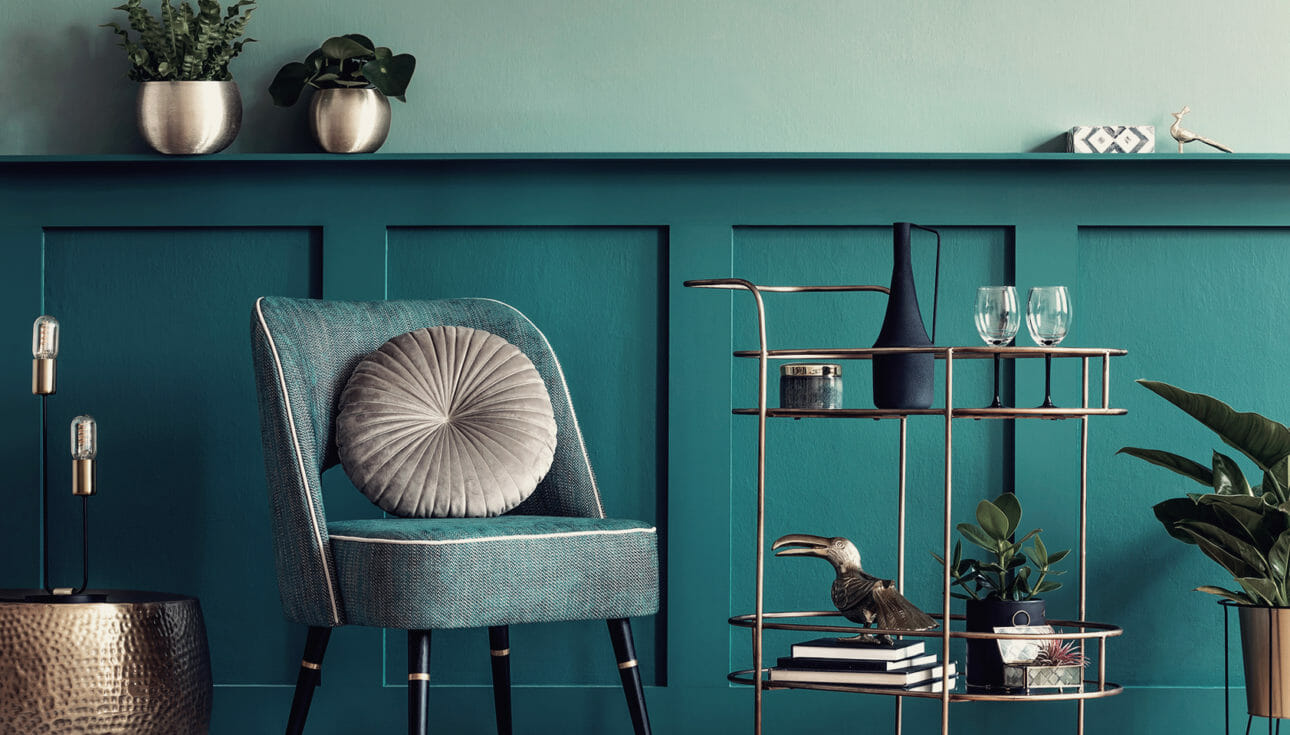 Teal themed room filled with gold metal trendy home decor.