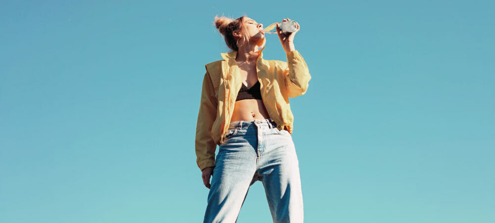 A woman drinking outside