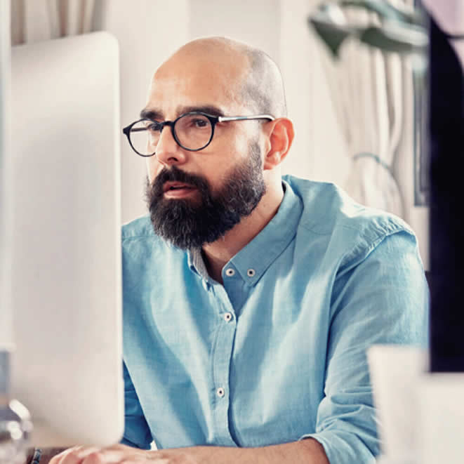 Man with glasses searching a website for products showing the power of Lily AI on SEO and SEM.