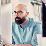Man with glasses searching a website for products showing the power of Lily AI on SEO and SEM.