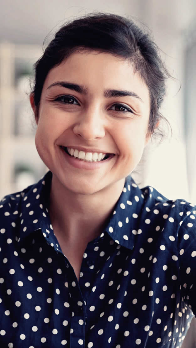 Woman smiling who is happy after online shopping a fashion website's recommendations.