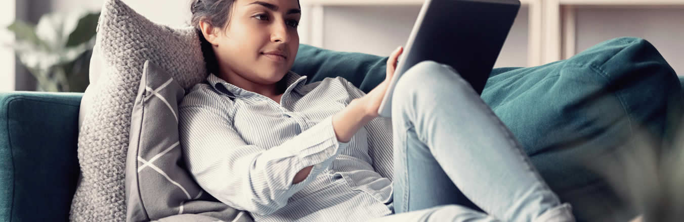 Woman using laptop on couch