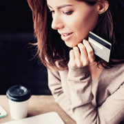 Woman online shopping product recommendations with her credit card out.